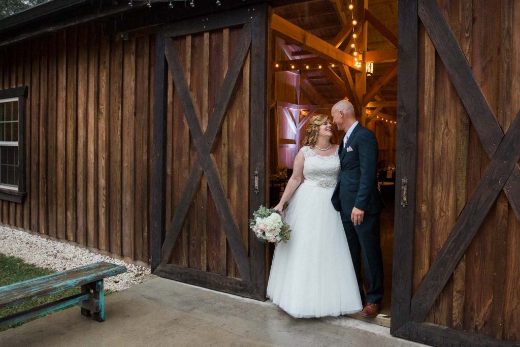 bride and groom in barn door