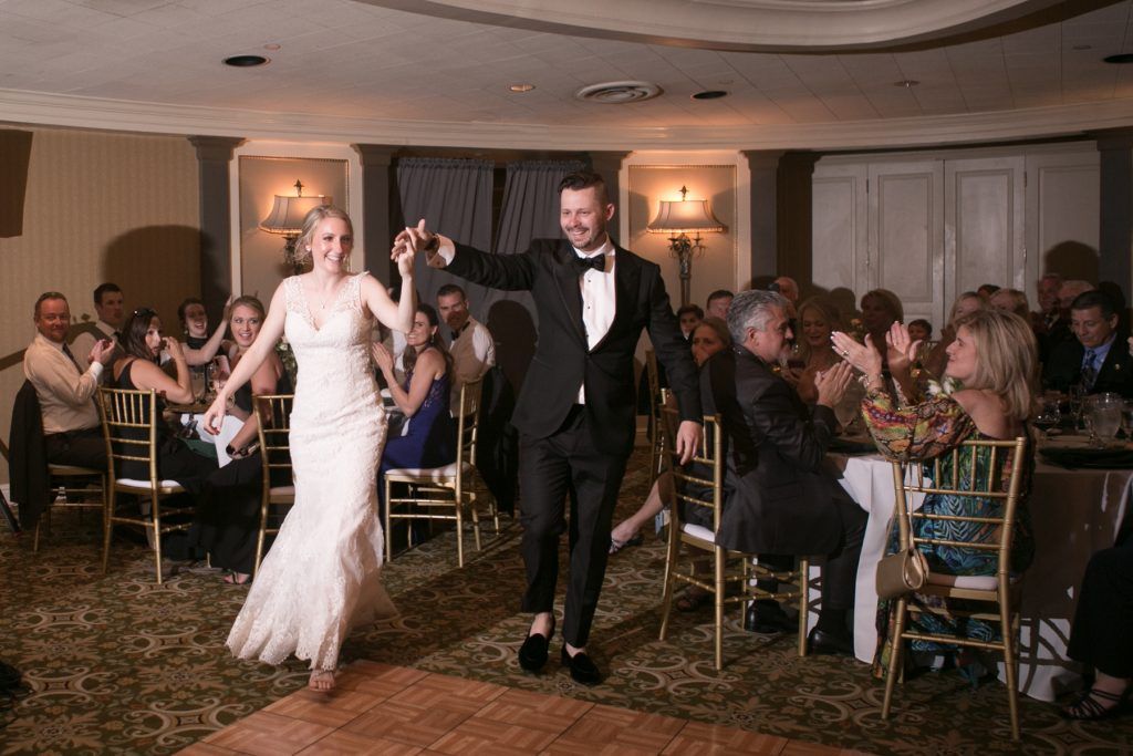 bride and groom enter wedding reception in style
