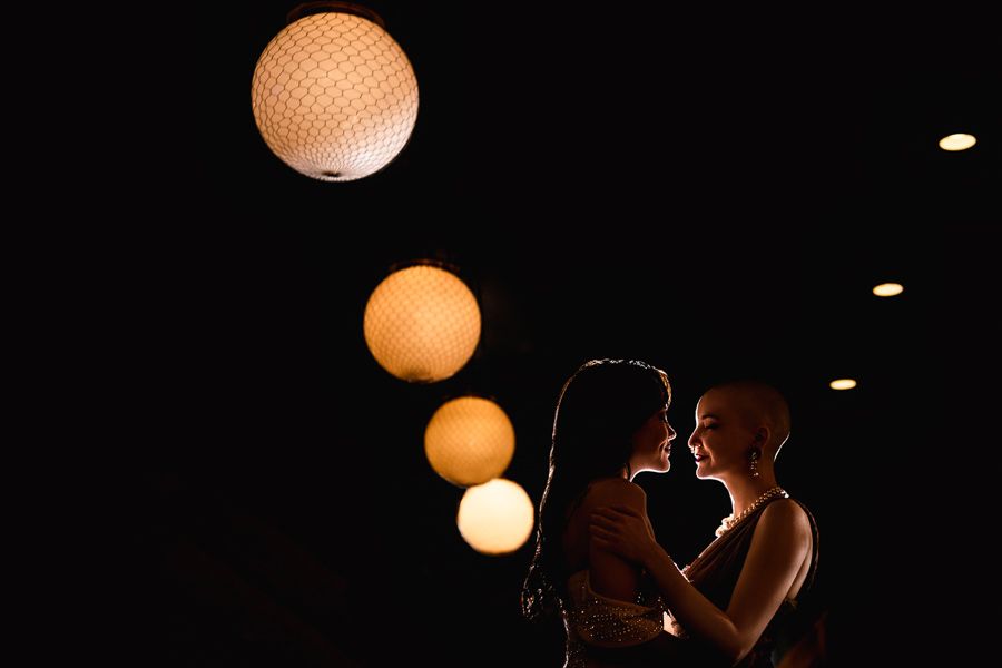 bride and partner staring at each other lovingly under chinese lanterns on i said yes
