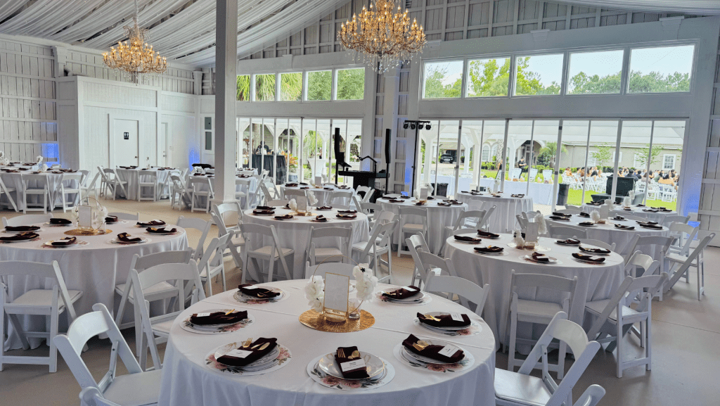 Simple white themed wedding with floral placemats and black and gold utensils