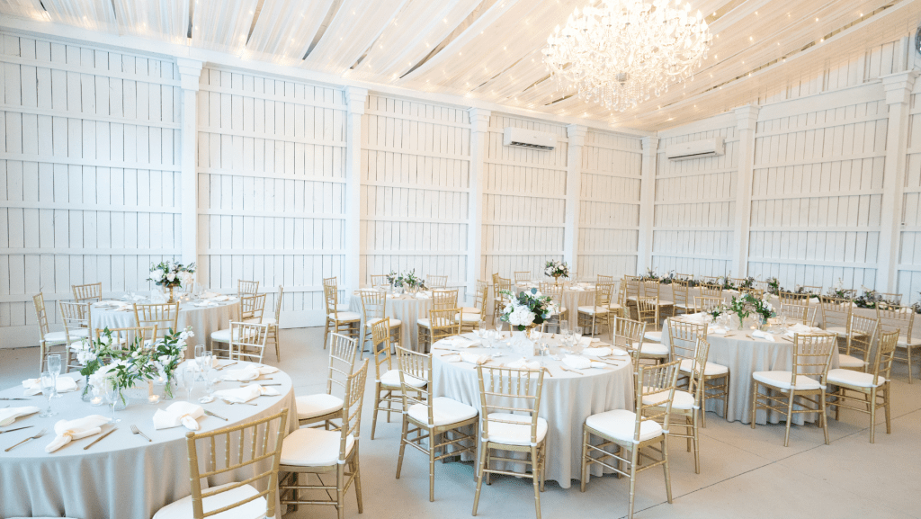 elegant white themed wedding with greenery and white floral centerpieces