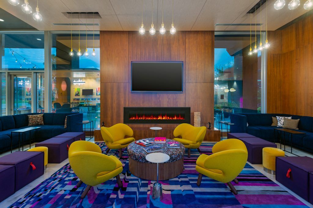 Vibrant lounge chairs and couch in Aloft Orlando Downtown on I Said Yes! FL