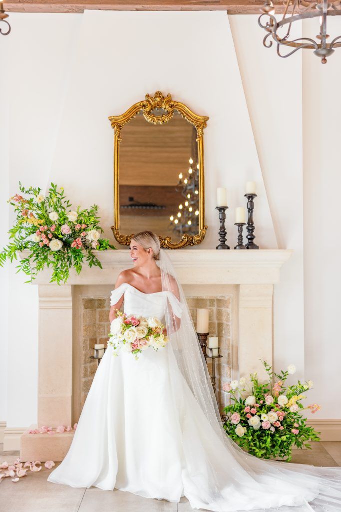 bride smiling and looking to her right with beautiful spring wedding bouquet