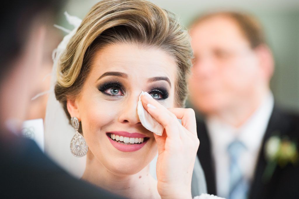 close up photo of bride happily crying on her wedding day