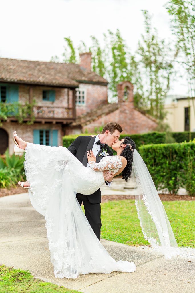 groom dipping bride for kiss with dress draping down