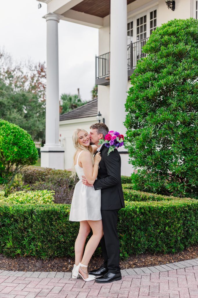 groom kissing bride's cheek at wedding venue in Central Florida
