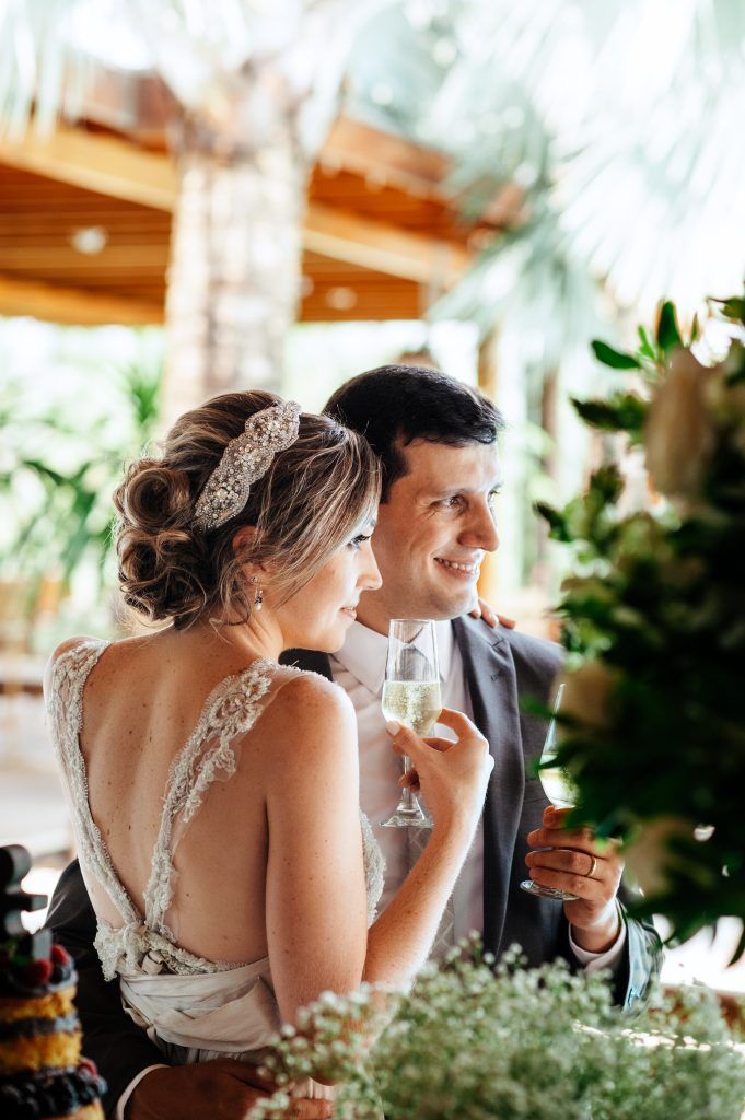 happy and smiling married couple drinking champagne on I Said Yes! FL