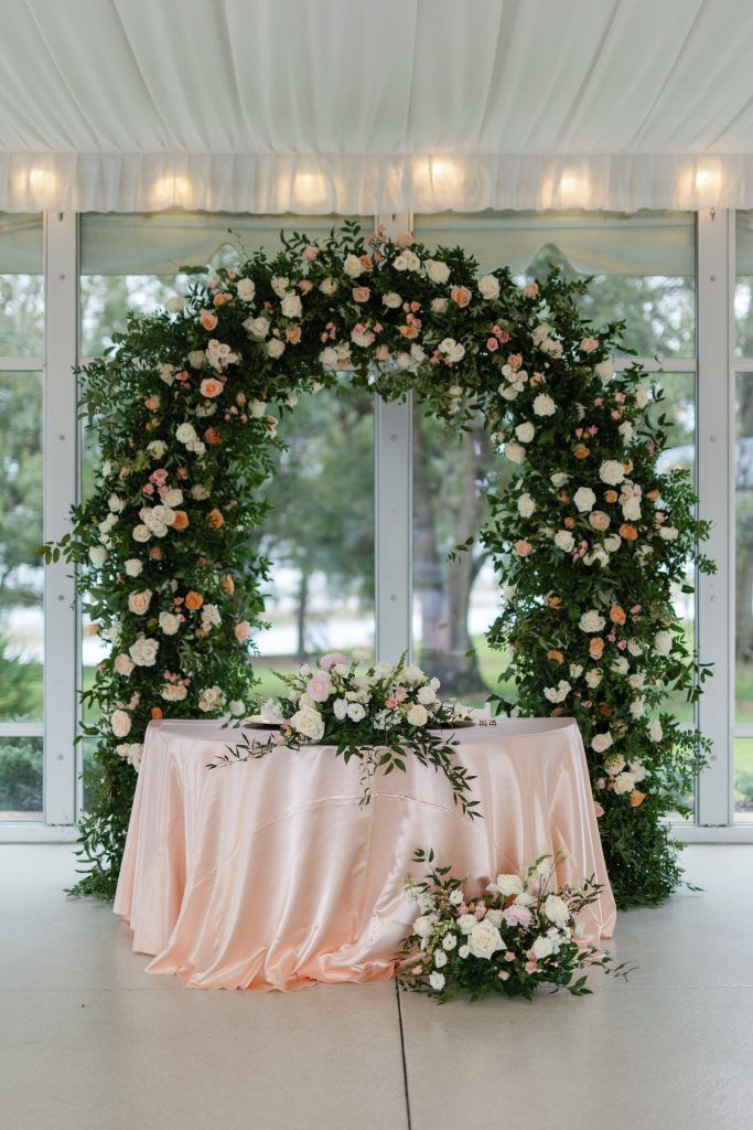 lush green arch with white and pink roses created by jill heaton event decor