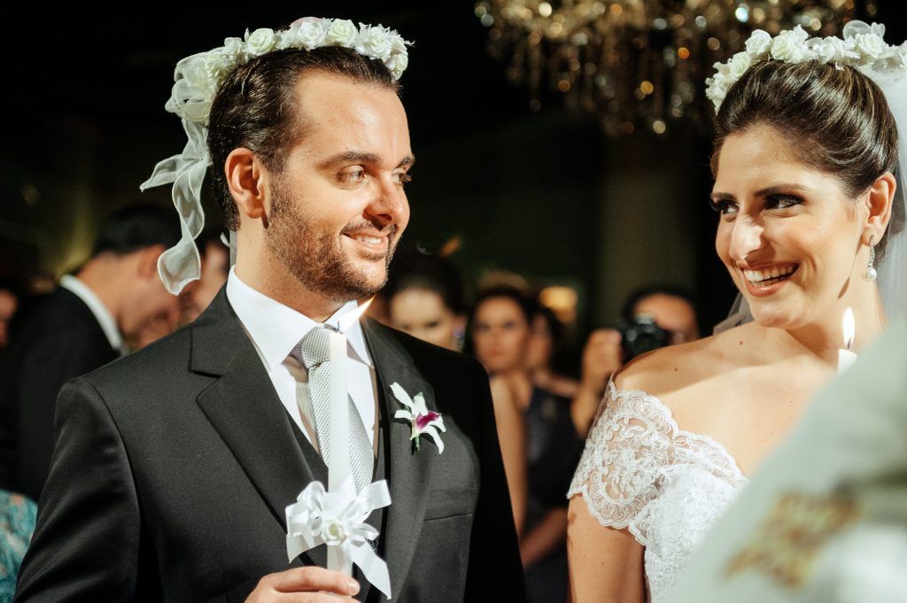 married couple smiling at each other on their wedding night