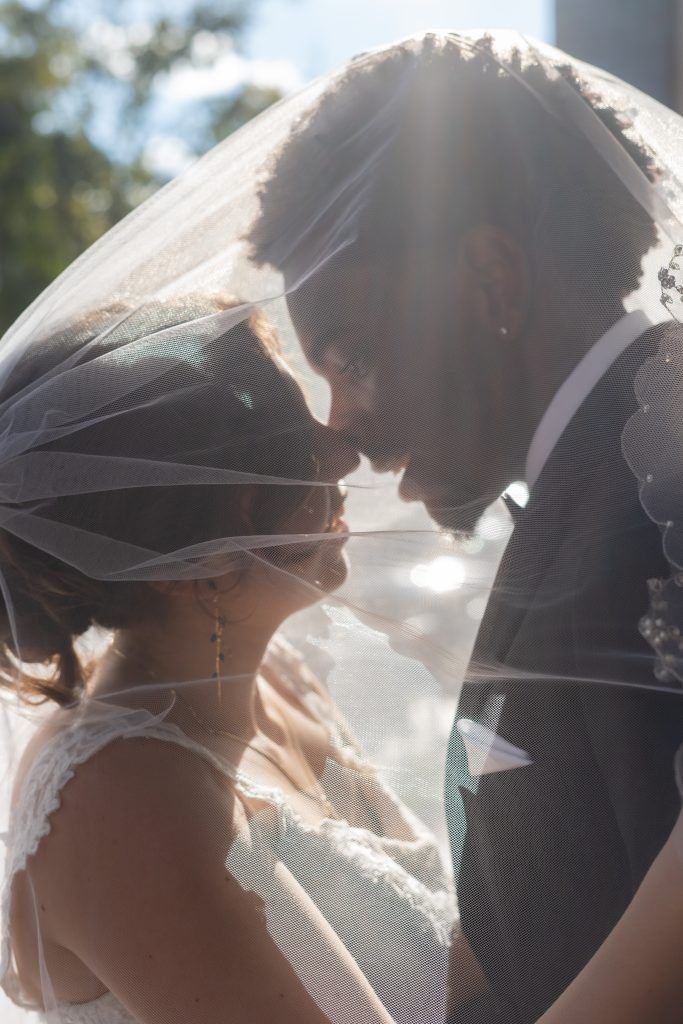 bride and groom kissing beneath the veil by Christina Foulds Photography, Orlando & Central Florida wedding photographer