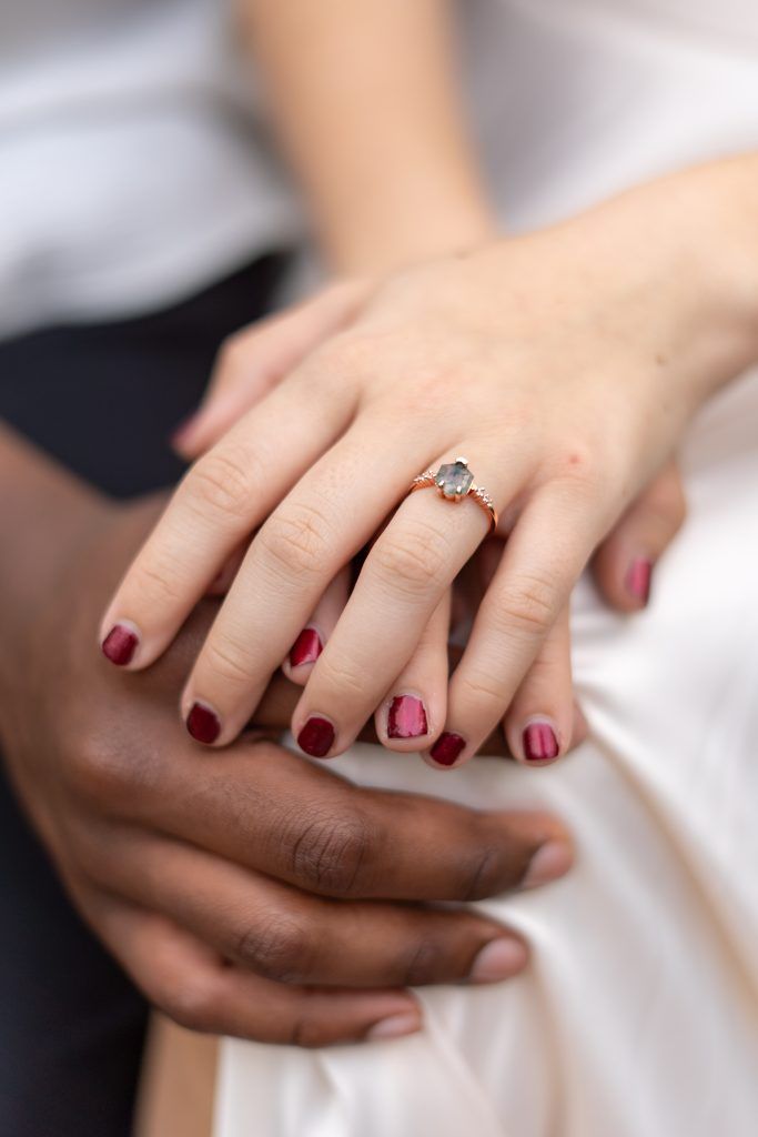 Close up of bride and groom holding hands by Christina Foulds Photography