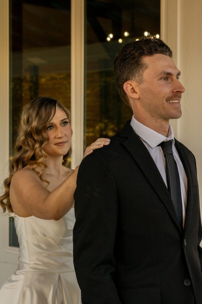 bride tapping grooms shoulder captured by Christina Foulds Photography, Orlando & Central Florida wedding photographer