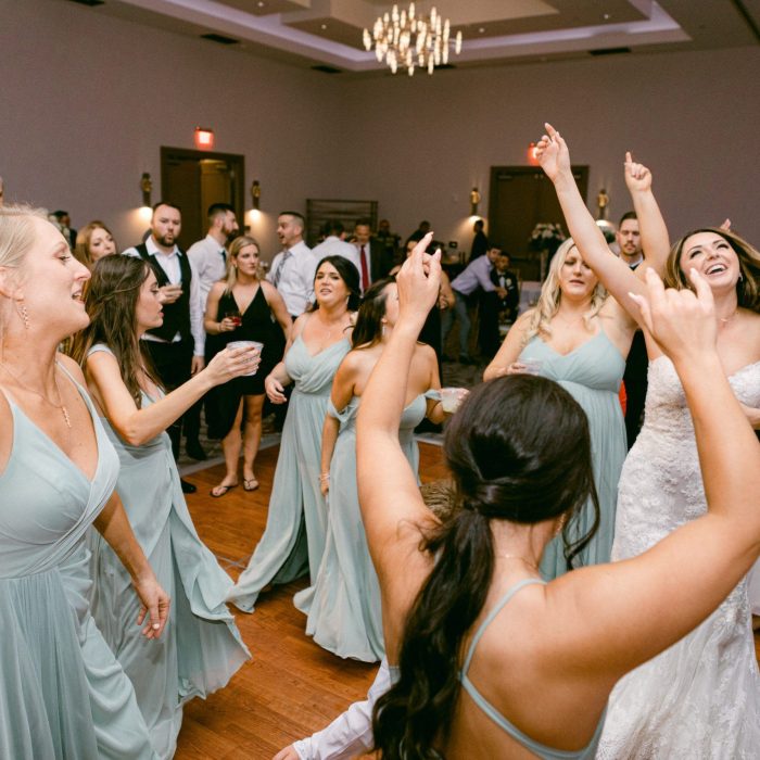 bride_and_bridesmaids_smiling_while_dancing_at_the_celeste_hotel_on_I_Said_Yes_FL